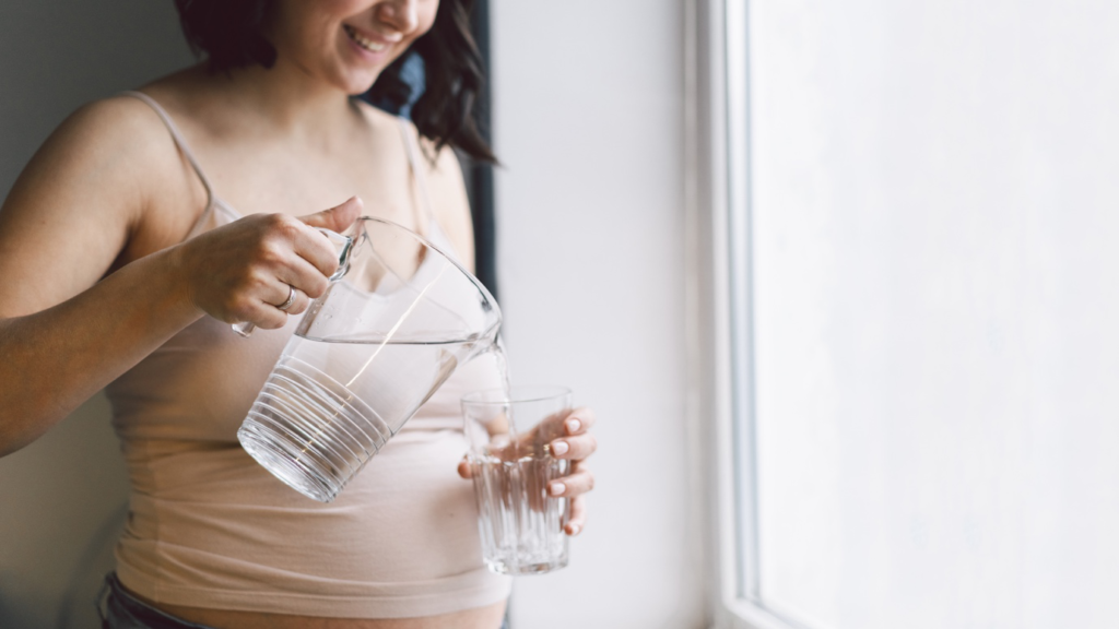 : A pregnant woman drinking water before ultrasound