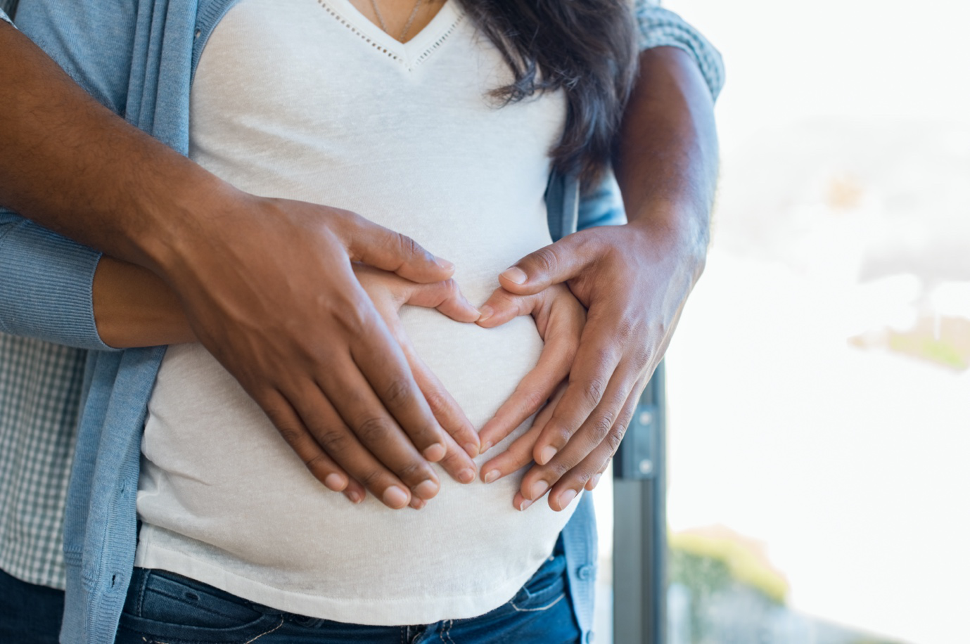 Expectant couple holding the mother’s belly