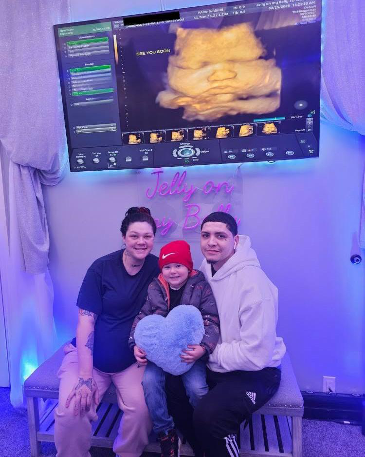 A couple attending an ultrasound session with their first born
