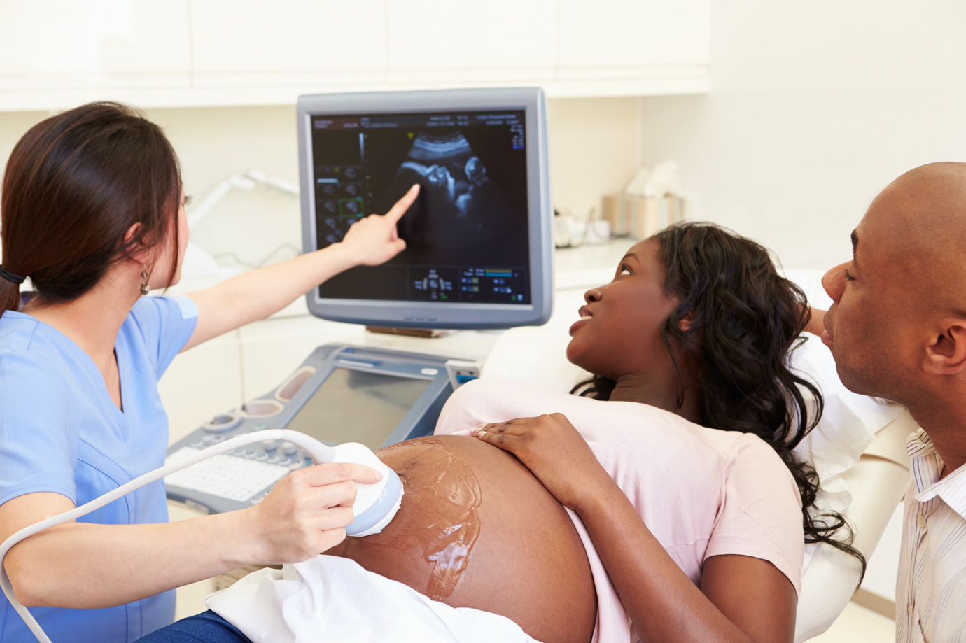 A father attending a pregnancy ultrasound with his expectant partner